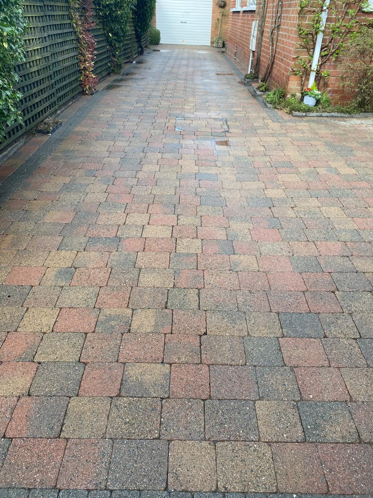 Cleaned block-paved driveway leading to a garage