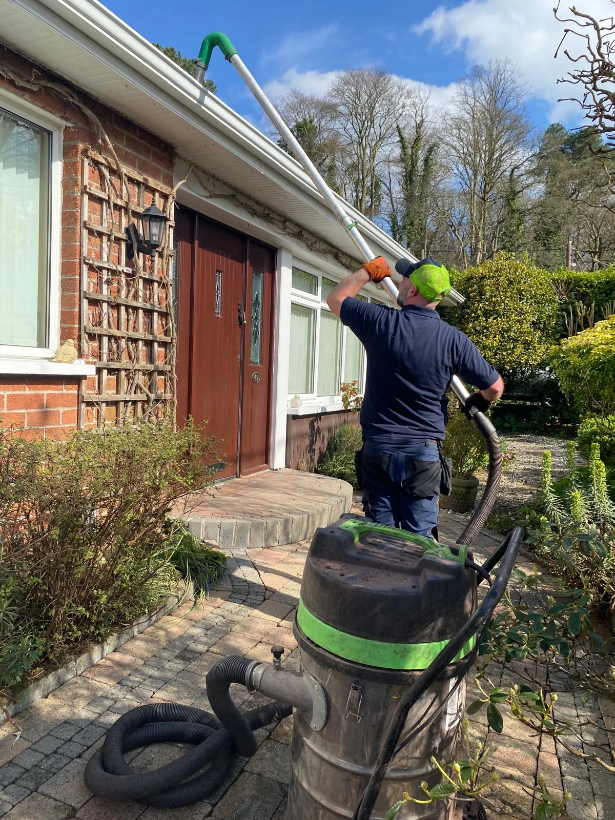 Gutter-vac clearance in progress at a home