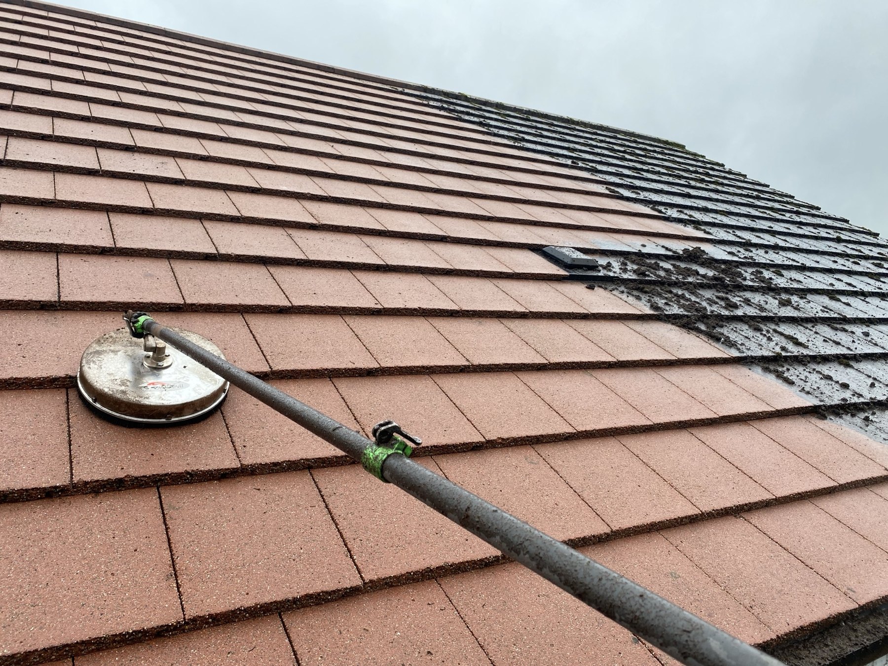 Roof cleaning in progress with specialist equipment