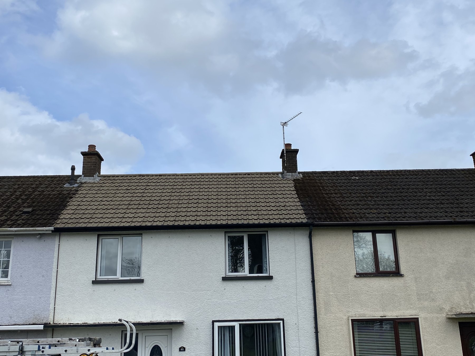 Terraced homes with a partly cleaned roof
