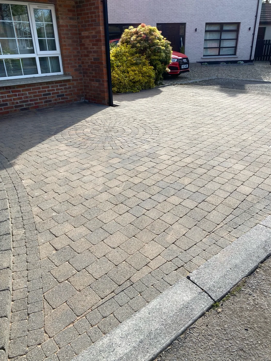 Cleaned paved driveway at a roof-to-drive exterior clean