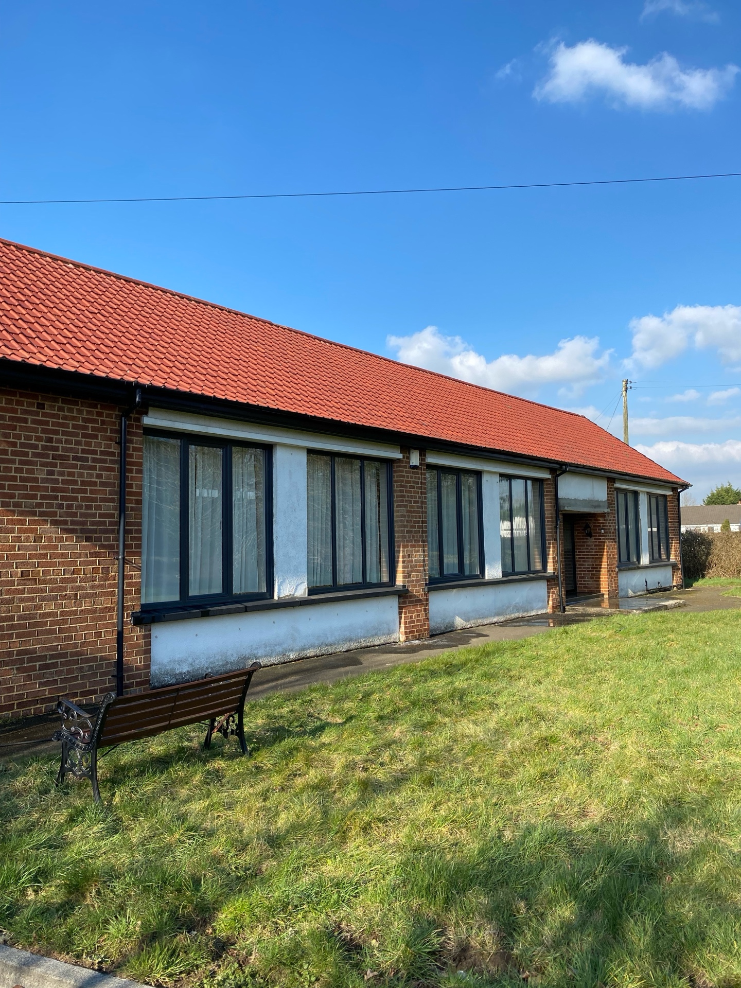 Converted schoolhouse after steam cleaning of clay roof tiles and brickwork