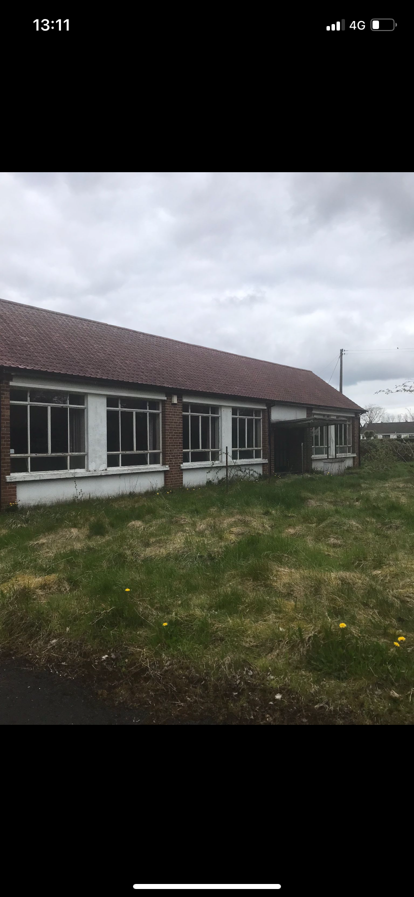Former schoolhouse before conversion, showing weathered clay roof tiles and brickwork